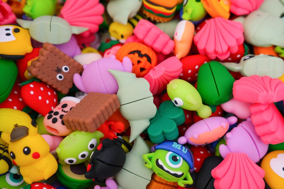 Vibrant mascot characters playfully peeking around a corner in a modern urban environment.