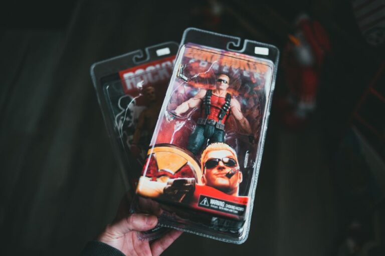 From above of crop unrecognizable person showing superhero toy packed in transparent plastic box